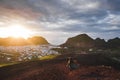 Woman enjoying sunset on peak Eldfell volcano with view of Vestmannaeyjar island