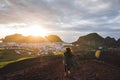 Woman enjoying sunset on peak Eldfell volcano with view of Vestmannaeyjar island