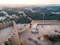 Woman enjoying sunset view from Dhayah fort in the UAE