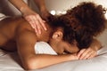 Woman enjoying therapeutic neck massage in spa