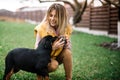 Woman enjoying time with cheerful rottweiler puppy