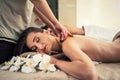 Woman enjoying traditional hot stone massage next to her partner Royalty Free Stock Photo