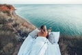 Woman enjoying view on beach landscape while relaxing in bed in sunset on the edge of Earth Royalty Free Stock Photo