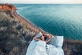 Woman enjoying view on beach landscape while relaxing in bed in sunset on the edge of Earth Royalty Free Stock Photo