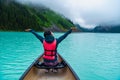 Woman enjoying the view of Lake Louise from Canoe