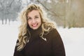 Woman enjoying a winter walk through snow covered park