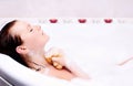 Woman enjoys the bath-foam in the bathtub. Royalty Free Stock Photo