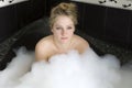 Woman enjoys the bath-foam in the bathtub. Royalty Free Stock Photo