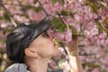 Woman enjoys beautiful branches blooming sakura flowers. Royalty Free Stock Photo