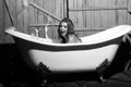 Woman enjoys a hot bath. Beauty fashion model portrait. Laughing woman in bath