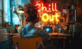 Woman enjoys music with headphones in a bohemian room with Chill Out neon sign, embodying a relaxed and cozy lifestyle