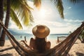 A woman enjoys a peaceful moment as she sits in a hammock on the beach, soaking in the sun and tranquility, A woman enjoying the Royalty Free Stock Photo