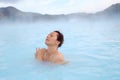Woman enjoys spa in geothermal hot spring