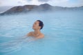 Woman enjoys spa in geothermal hot spring