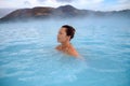 Woman enjoys spa in geothermal hot spring