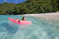 Woman enjoys sunny day at Caribbean beach.