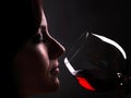 Woman enjoys the taste and the bouquet of a glass of red wine Royalty Free Stock Photo