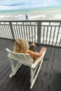 woman enjoys the view from an old victorian balcony to the colorful sea of Mexico in Galveston, Texas