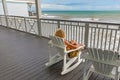 woman enjoys the view from an old victorian balcony to the colorful sea of Mexico in Galveston, Texas