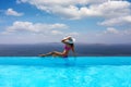 Woman enjoys the view from the pool to the Mediterranean sea Royalty Free Stock Photo