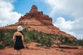 Woman enjoys the view of the Sedona landscape from the top of the Bell Rock hiking trail, famous for its many energy