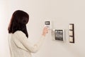 Woman entering code on keypad of home security alarm Royalty Free Stock Photo