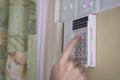 Woman entering code pin on home alarm system keypad Royalty Free Stock Photo