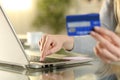 Woman entering credit card numbers on a laptop at home Royalty Free Stock Photo