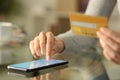 Woman entering credit card numbers on phone at home Royalty Free Stock Photo