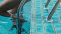 woman entering swimming pool