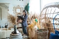 woman entrepreneur using a laptop among exotic handicrafts