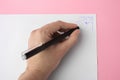 Woman erasing web drawn with erasable pen on sheet of paper against pink background, top view Royalty Free Stock Photo