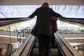 Woman on escalator in shopping mall centre Royalty Free Stock Photo