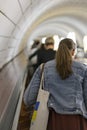 Woman on escalator view from the back. vertical photo Royalty Free Stock Photo