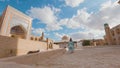 Woman in ethnic dress near Madrassah in Ichan Kala of Khiva