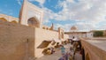 Woman in ethnic dress near Madrassah in Ichan Kala of Khiva