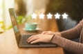 Woman evaluating company with high five stars rating