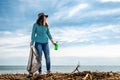 A woman on the eve of the holiday earth Day provides volunteer assistance in cleaning the coastal area of debris. Earth day and
