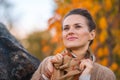 Woman in evening autumn park thoughtfully looking aside Royalty Free Stock Photo