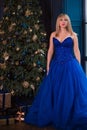 Christmas cozy atmosphere at event, pretty lady in blue dress Royalty Free Stock Photo