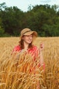 A woman in the evening in wheat field examines the ears Royalty Free Stock Photo