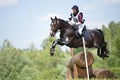 Woman eventer on horse is overcomes the Log fence Royalty Free Stock Photo