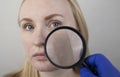 A woman examines dry skin on her face. Peeling, coarsening, discomfort, skin sensitivity. Patient at the appointment of a