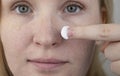 A woman examines dry skin on her face. Peeling, coarsening, discomfort, skin sensitivity. Patient at the appointment of a