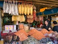 A woman examines fish for sale at a market stall around the Central Market in Phnom Penh, Cambodia