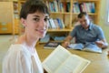 woman examining books in library Royalty Free Stock Photo