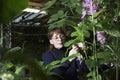 Woman Examining Flowers Royalty Free Stock Photo