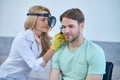 Woman examining mans ear through frontal reflector Royalty Free Stock Photo