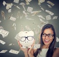 Woman excited over savings under money rain falling down dollars