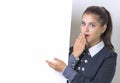 woman excited pointing on empty blank billboard paper sign board. Young business woman isolated on white background Royalty Free Stock Photo